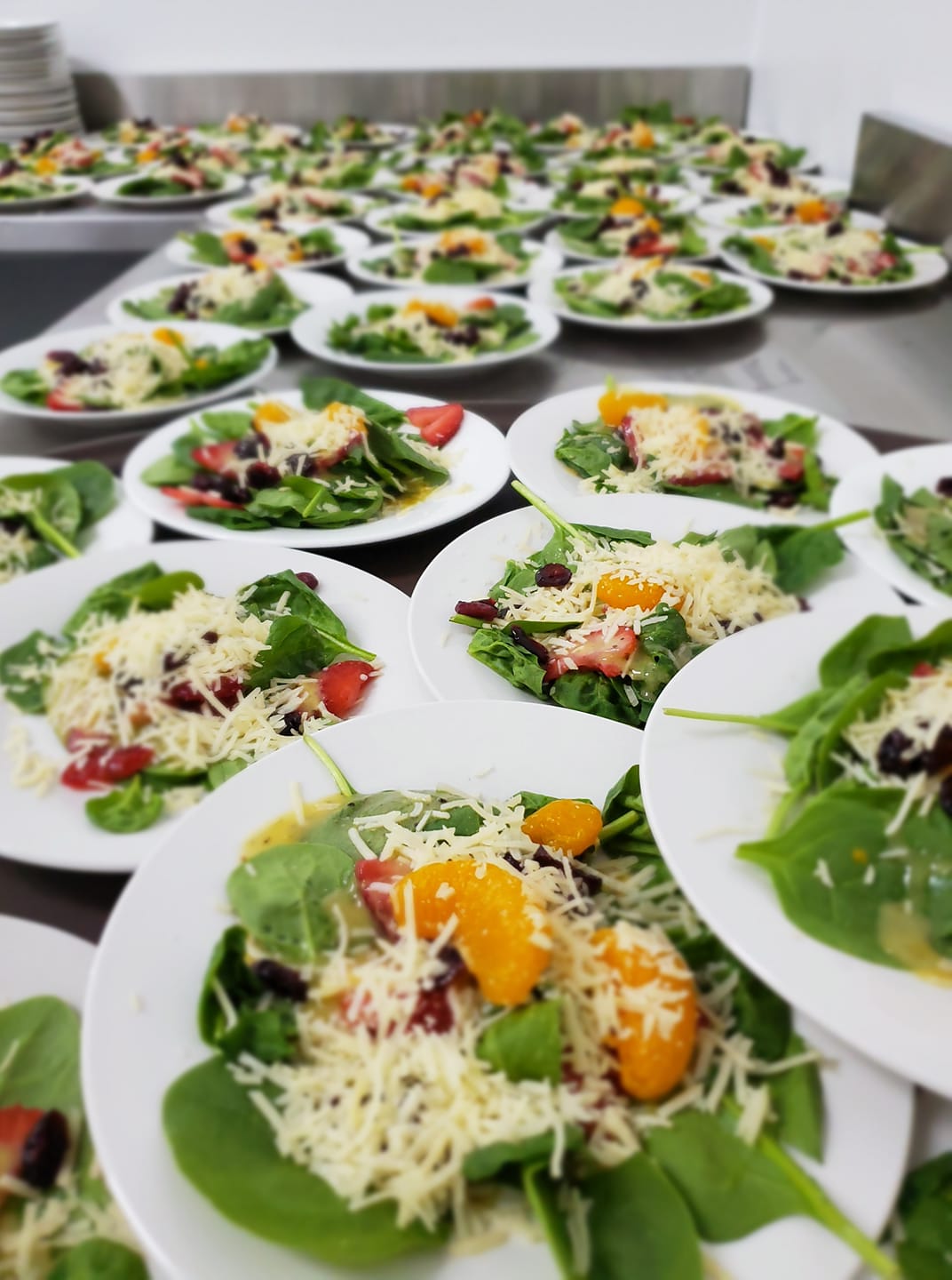 plated spinach salad with mandarins and strawberries